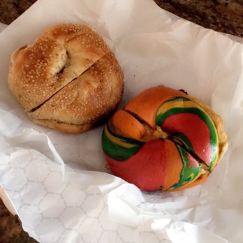 Queens Bagels & Delicatessen - Rainbow bagel lightly toasted w/egg and butter; sesame bagel lightly toasted w/butter - Bagels Near Me - Forest Hills, New York