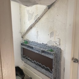 Old wall, crappy old electric fireplace.