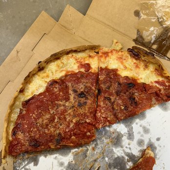 Lou Malnati's Pizzeria - a half eaten pizza - Pizza Near Me - Naperville, Illinois