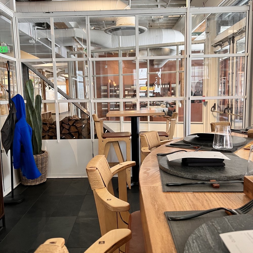 Brutø - a long table with a laptop on it - Tapas/Small Plates Near Me - Denver, Colorado Brutø - a long table with a laptop on it - Tapas/Small Plates Near Me - Denver, Colorado
