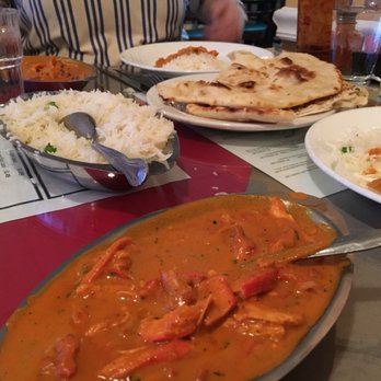 Guru India - Chicken tikka masala with garlic and regular naan in the background - Indian Near Me - Crescent Springs, Kentucky Guru India - Chicken tikka masala with garlic and regular naan in the background - Indian Near Me - Crescent Springs, Kentucky