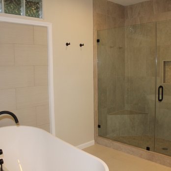 Your Kitchen Pro - a bathtub and shower in a bathroom - General Contractors Near Me Your Kitchen Pro - a bathtub and shower in a bathroom - General Contractors Near Me