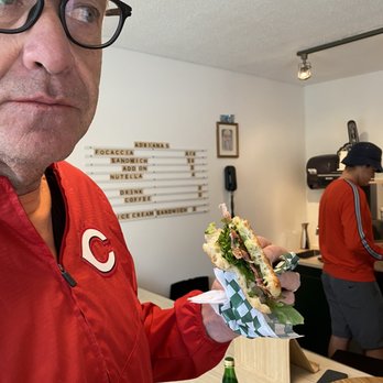 Adriana’s - a man holding a sandwich - Sandwiches Near Me - Tofino, British Columbia