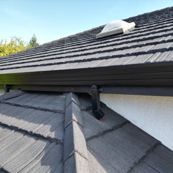 Garner Roofing - The fix to stop the standing water. They installed spouts in the middle and have them drain on the roof below. - Roofing Near Me - Rancho Cordova, California