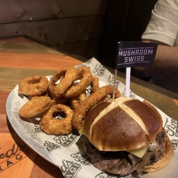 Ford's Garage Plano - Swiss Mushroom Burger with hand battered onion rings - Burgers Near Me - Plano, Texas Ford's Garage Plano - Swiss Mushroom Burger with hand battered onion rings - Burgers Near Me - Plano, Texas