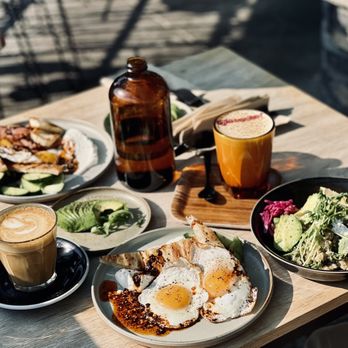 Sunhouse Cafe - a wooden table with plates of food on it - Cafes Near Me - Jasper, Alberta