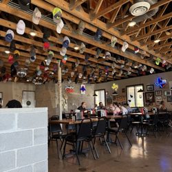 Maple & Motor - Ball/trucker caps hanging from the ceiling!