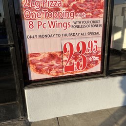 a pizza advertisement in a window a pizza advertisement in a window