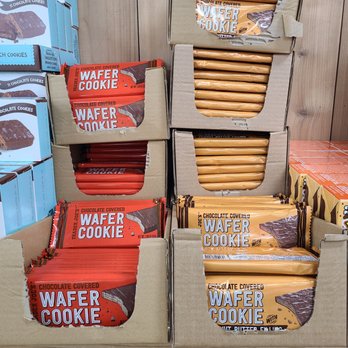 Trader Joe's - Trader Joe's wafer cookies are arranged in open cardboard boxes, with red and tan packaging visible. - Grocery Near Me - Temecula, California