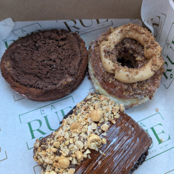 La Rue Doughnut - Top: Chocolate crumb and forgotten. Bottom: Chocolate Pain Suisse. Favorite one in the box but they do have better options. - Bakeries Near Me - Dallas, Texas La Rue Doughnut - Top: Chocolate crumb and forgotten. Bottom: Chocolate Pain Suisse. Favorite one in the box but they do have better options. - Bakeries Near Me - Dallas, Texas