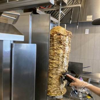 Shawarma Flavors - a woman preparing food in a commercial kitchen - Middle Eastern Near Me - Mississauga, Ontario Shawarma Flavors - a woman preparing food in a commercial kitchen - Middle Eastern Near Me - Mississauga, Ontario