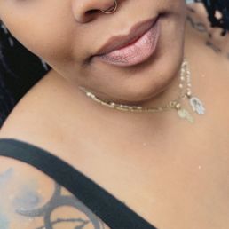 Septum piercing with gold hoop, jewelry.