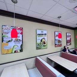 a woman sitting at a table in a restaurant a woman sitting at a table in a restaurant