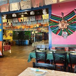 tables and chairs in a brightly decorated restaurant