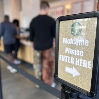 Starbucks - a sign that reads welcome please enter here - Coffee & Tea Near Me - San Francisco, California