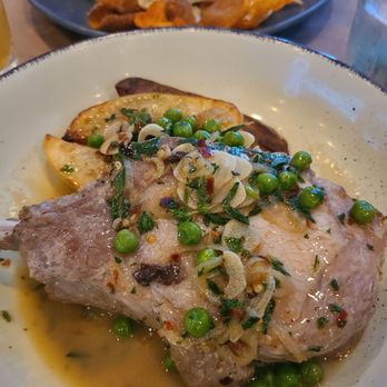 The Artichoke Cafe - Pork chop with roasted potatoes and peas - New American Near Me - Albuquerque, New Mexico