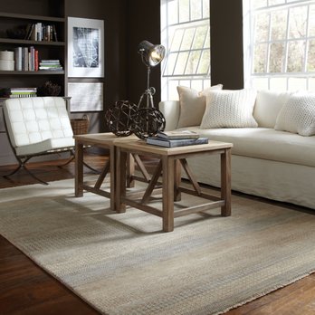 Carlson's Flooring - a living room with a couch, chair, coffee table and bookshelf - Carpeting Near Me - Geneva, Illinois