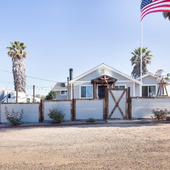 Bluegrass Project Pro's - a white house with a flag flying in front of it - Handyman Near Me Bluegrass Project Pro's - a white house with a flag flying in front of it - Handyman Near Me