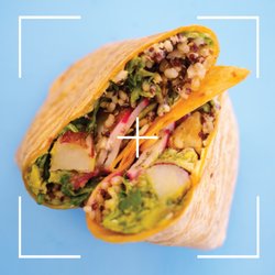 Vitality Bowls - Vitality Wrap with greens, grains, roasted potato, radish, vegan garlic aioli, avocado, hummus on a tomator basil tortilla.