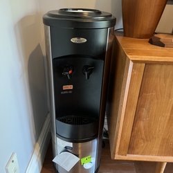 Empty water cooler gathering dust, waiting for a delivery.