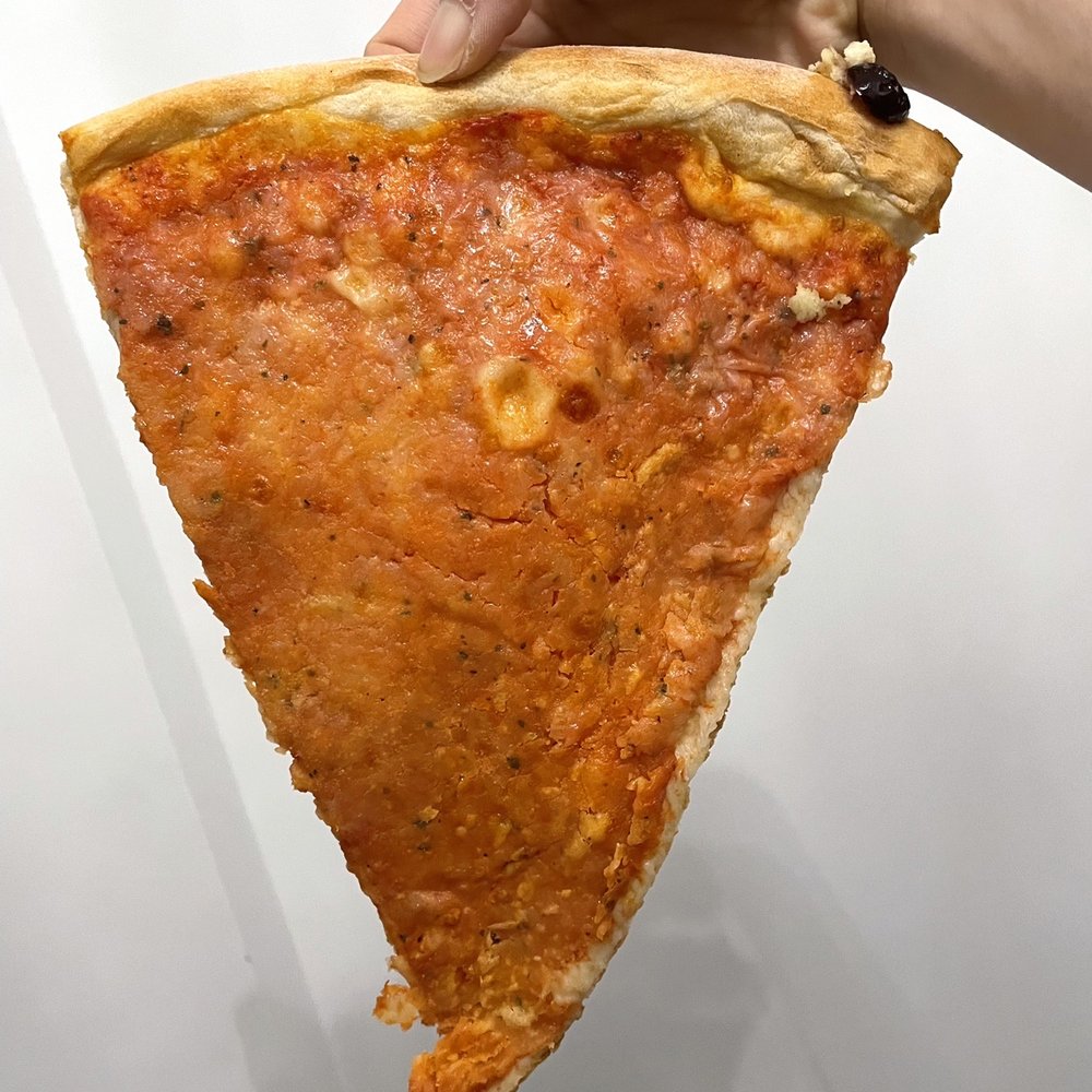 Queen Pizza II - a hand holding a slice of pizza - Italian Near Me - Newark, New Jersey Queen Pizza II - a hand holding a slice of pizza - Italian Near Me - Newark, New Jersey