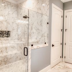 Floor Authority - A walk in shower installed with 12x24 tiles and a mosaic niche