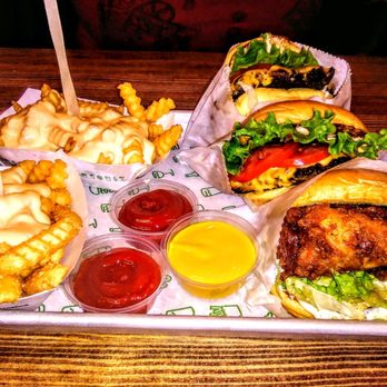 Shake Shack Forest Hills - 2 cheese burgers and French toast  with a chicken breast sandwich with lettuce and tomatoes - Burgers Near Me - Forest Hills, New York