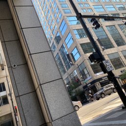 a street corner with a tall building in the background