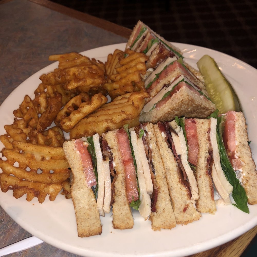 a plate of sandwiches and french fries