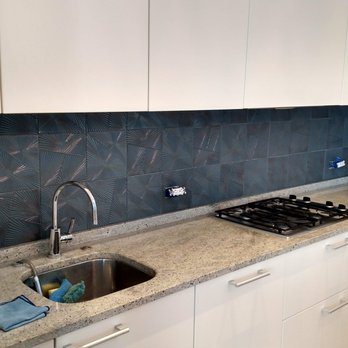 Olger Construction - a kitchen with a sink and stove - General Contractors Near Me