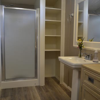 R. A. Stephens - Rudy turned a useless space into a linen cabinet and added trim to an existing mirror.  He installed this vinyl plank flooring. - General Contractors Near Me - Saint Augustine, Florida
