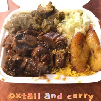 Caribbean Hut - a plate of food with meat and rice - Caribbean Near Me - Gastonia, North Carolina