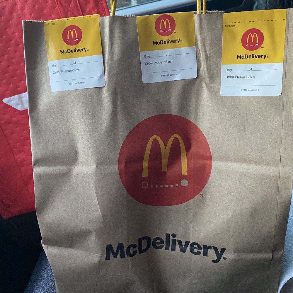 a paper bag with mcdonald's delivery stickers on it a paper bag with mcdonald's delivery stickers on it