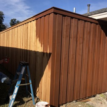 Castañeda Construction - a wooden fence and a bucket of paint - General Contractors Near Me Castañeda Construction - a wooden fence and a bucket of paint - General Contractors Near Me