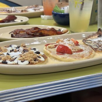 Snooze, an A.M. Eatery - Pancake flight with strawberry shortcake, blueberry danish, and pineapple upside down. - Breakfast & Brunch Near Me - Charlotte, North Carolina Snooze, an A.M. Eatery - Pancake flight with strawberry shortcake, blueberry danish, and pineapple upside down. - Breakfast & Brunch Near Me - Charlotte, North Carolina