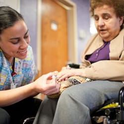 The Holiday Retirement - A staff member helping a resident paint her nails.
