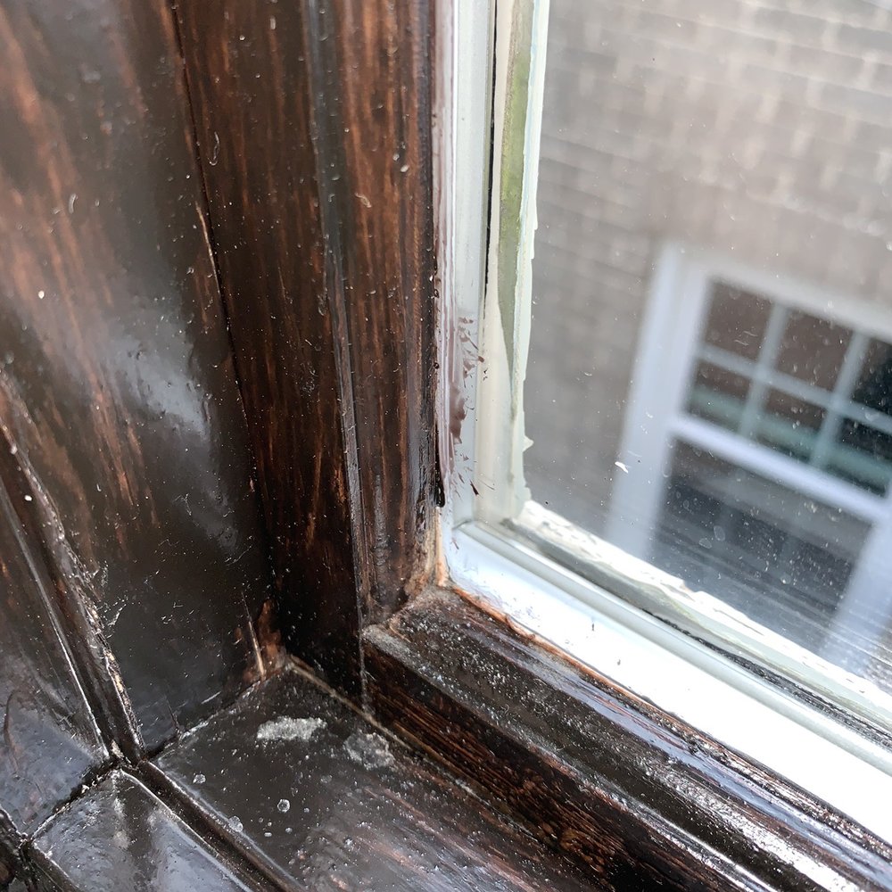 Paint on the window, dust and drips on the frame.