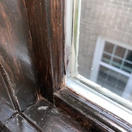 Paint on the window, dust and drips on the frame.