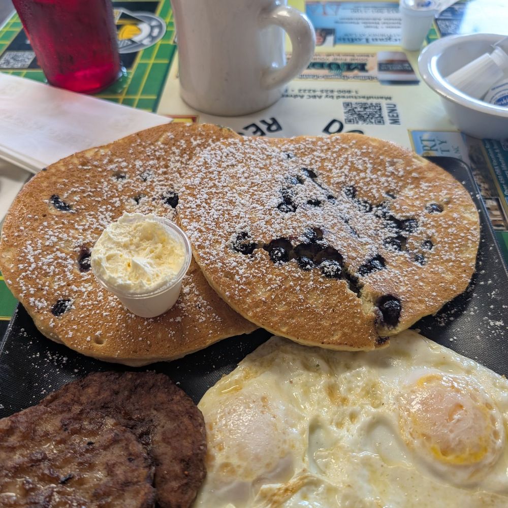 Blueberry pancakes with eggs and sausage Blueberry pancakes with eggs and sausage