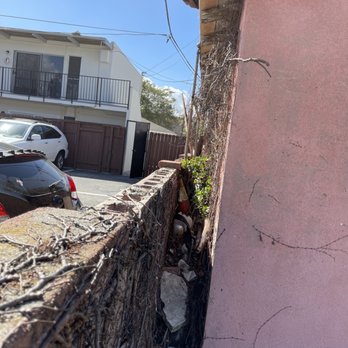 De’Guerrero Design & Build - Before. Trash from the apartments next door had a decade of accumulation against the garage. - Landscaping Near Me De’Guerrero Design & Build - Before. Trash from the apartments next door had a decade of accumulation against the garage. - Landscaping Near Me