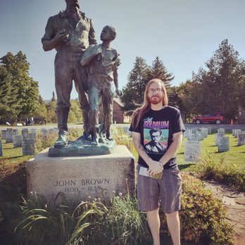 John Brown's Farm - In front of the statue of John Brown. In the background is the Memorial Field. - Local Flavor Near Me - Lake Placid, New York