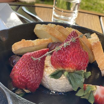 The Charleston Draper - Baked Brie appetizer with honeyed dates, thyme sprigs, crostini, and sliced strawberries. Delightful. - New American Near Me - Draper, Utah The Charleston Draper - Baked Brie appetizer with honeyed dates, thyme sprigs, crostini, and sliced strawberries. Delightful. - New American Near Me - Draper, Utah