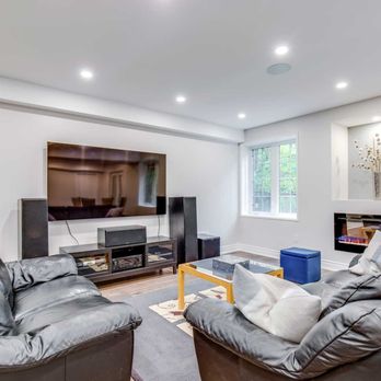 RenoDuck - a living room with couches and a flat screen tv - General Contractors Near Me - Toronto, Ontario