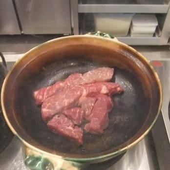Nanzan GiroGiro - Beef being cooked in a hot nabe pot - Japanese Near Me - Honolulu, Hawaii