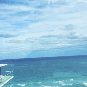 Grand Beach Hotel Surfside - Glassed in rooftop pool area looking over beach on left side and city on right. - Hotels Near Me - Surfside, Florida