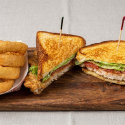 BLT Sandwich with fried onion rings.