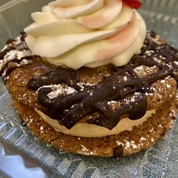 Emerson Commons - School of Hospitality - Cookie sandwich with espresso creme filling, topped with whipped creme and a sliced strawberry