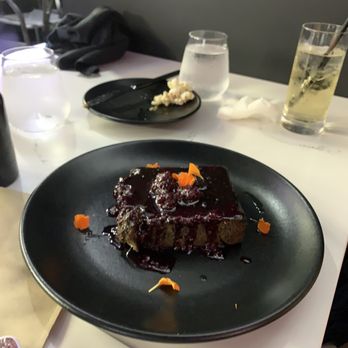 BLK SWAN - Lemon bread pudding. They use activated charcoal to make it black. - New American Near Me - Baltimore, Maryland
