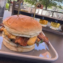 Bacon cheeseburger, flight of beers, view of the cuyahoga river in the background Bacon cheeseburger, flight of beers, view of the cuyahoga river in the background