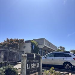 Stinson Beach Library - Library sign visible from the road. Parking log has ADA parking,